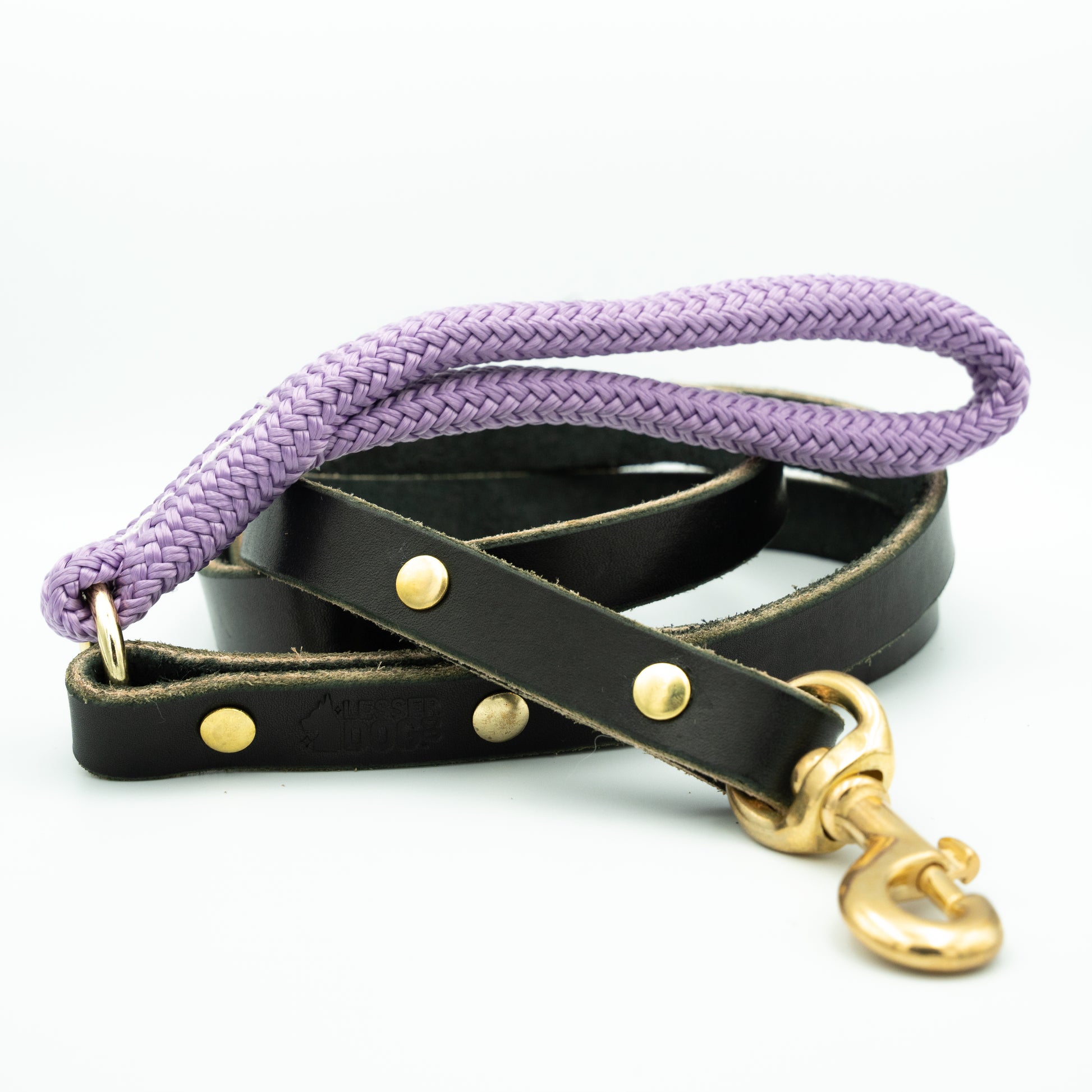 Dog leash with purple rope and black leather strap on a white background Aurora