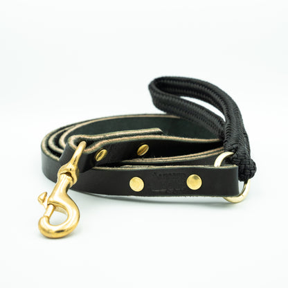 Black leather dog leash with gold hardware and black rope handle on a white background Eclipse