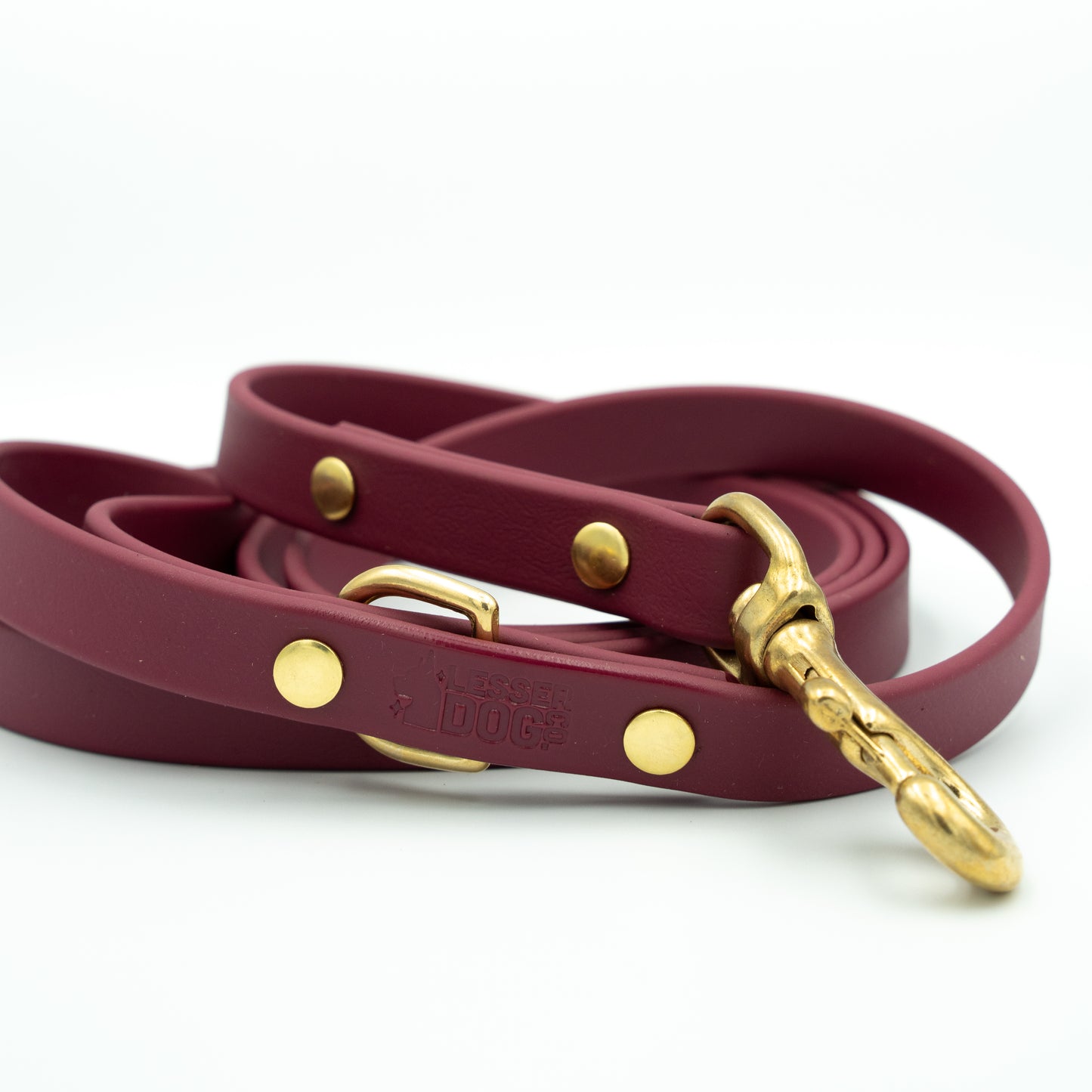 Maroon dog leash with gold hardware on a white background Garnet