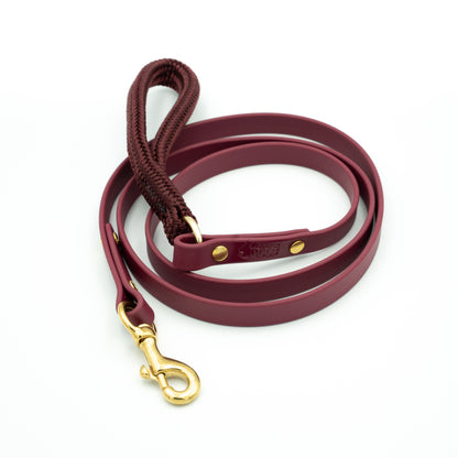 Maroon dog leash with gold clasp on a white background Garnet